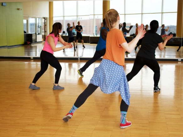 women dancing near mirror