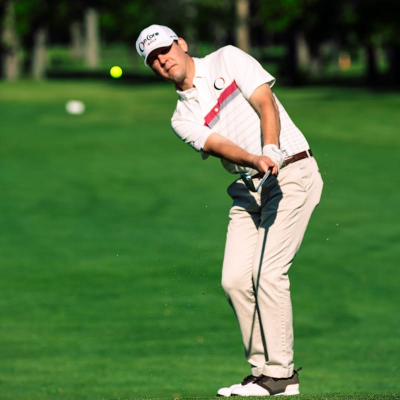 man in white crew neck t-shirt and gray pants holding golf club